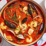 Cioppino recipe, Cioppino recipe, Seafood stew, San Francisco cuisine, Italian-American cuisine, Shellfish recipe, Fish recipe, Main course, Easy dinner recipe, Outdoor cooking, Grilling recipe, Campfire recipe, Crusty bread, White wine pairing, Pinot Grigio, Sauvignon Blanc, Seafood flavors, Shellfish dish, Fish dish, Seafood lovers, Seafood dinner, Seafood soup, Homemade Cioppino, Italian seafood recipe, Italian tomato sauce, Easy seafood recipe, Tomato-based soup, Hearty seafood dish, Customizable recipe, Leftover recipe, Refrigerator storage, Reheating instructions, Fresh seafood, Authentic Cioppino, Mediterranean recipe, Rich flavor, Satisfying texture, Seafood medley, Seafood feast, Fisherman's stew, Italian-American dish, West Coast cuisine, Pacific seafood, Seafood pot, One-pot meal, Warm and comforting, Homemade comfort food, Family recipe, Weeknight dinner idea Winter meal, Coastal cuisine,